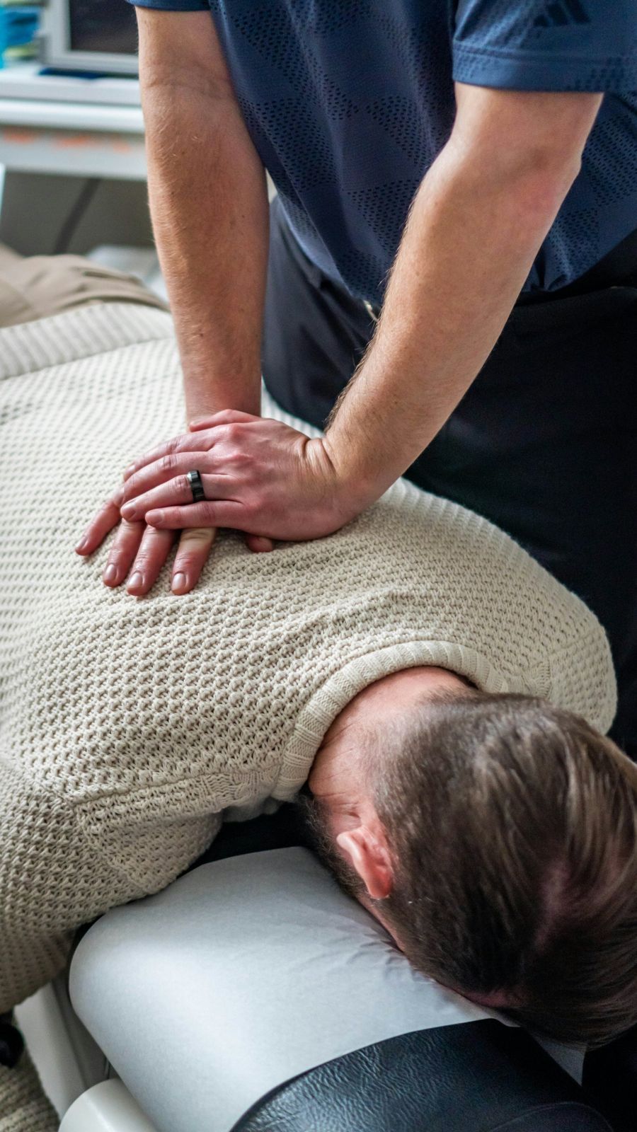 A therapist doing deep tissue work on a client's back